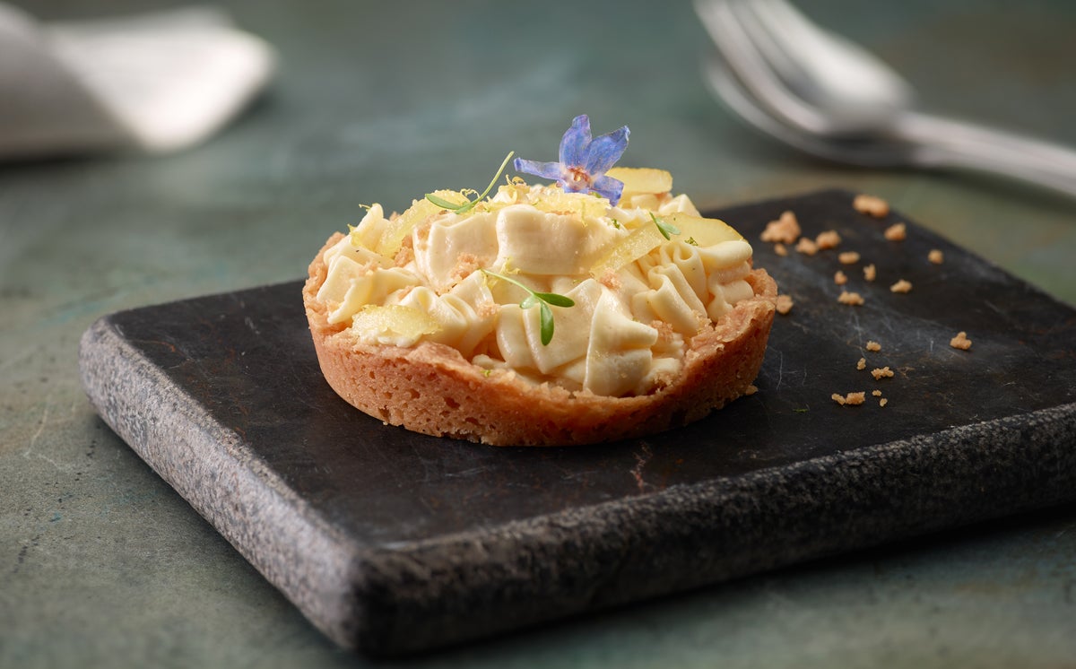 Se mete la crema fría en una manga pastelera. Se colocan en una placa las bases frías de galleta sablé y se rellenan con la crema. Se decora con algunos trozos de limón escarchado o de cáscara de limón o lima. ¡Y listo!