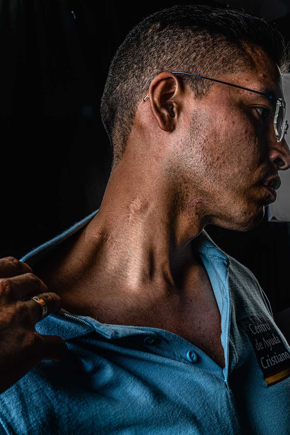 Kevin, Daniel, María y Andrés, los cuatro fueron miembros de bandas latinas en Madrid. Lograron salir con apoyo del Centro de Ayuda Cristiano. Bajo estas líneas, Daniel muestra la cicatriz, cerca de la yugular, que le dejó la puñalada de un latin king en una pelea en un parque del barrio madrileño de Usera. Tras cumplir condena en un centro de menores, se ordenó pastor evangélico.