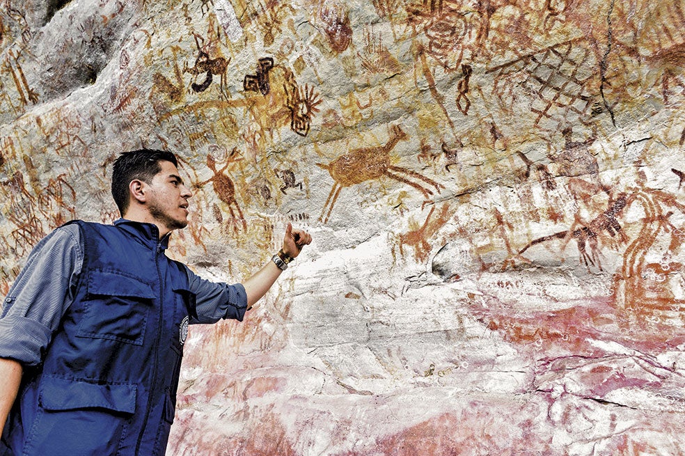 El experto Andrés López, ante un fresco de 30 metros de altura. Son pinturas difíciles de datar. Se estima que algunas tienen 20.000 años.