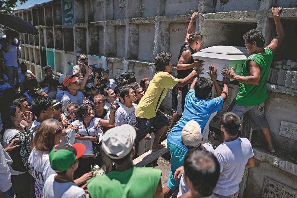 El ataúd de un hombre asesinado por los paramilitares es introducido en un nicho en Manila. «Si conoces a algún drogadicto, mátalo. Sería muy cruel pedírselo a sus padres», dijo Duterte en campaña para animar a los civiles a entrar en su particular guerra.